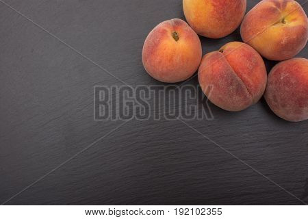 Ripe Peach Ion Black Background Of Slate Or Stone