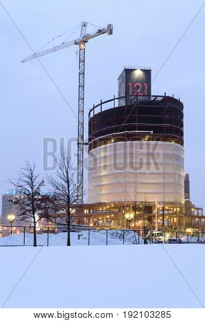 South Boston Massachusetts USA - February 16 2017: Crane looms over construction site at 121 Seaport project before dawn on winter morning in South Boston
