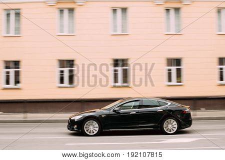 Gomel, Belarus - April 1, 2017: Black Color Tesla Model S Car In Motion On Street. The Tesla Model S Is A Full-sized All-electric Five-door, Luxury Liftback, Produced By Tesla Inc.