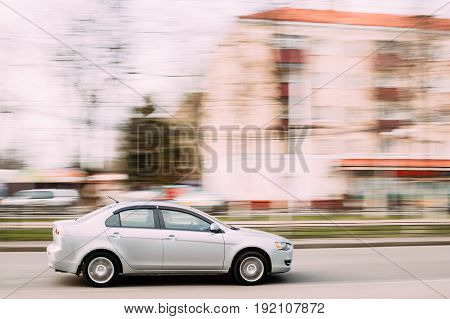 Gomel, Belarus - April 17, 2017: Gray Color Sedan Car Mitsubishi Lancer In Fast Motion On Street. The Mitsubishi Lancer Is A Compact Car Produced By The Japanese Manufacturer Mitsubishi Since 1973
