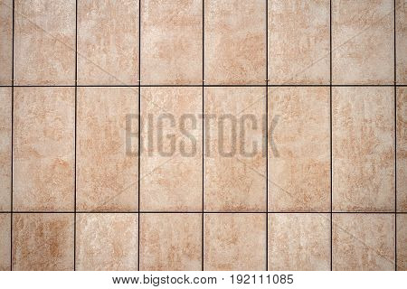 Detail of light beige tile wall texture background