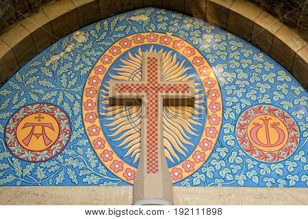 A Roman Catholic cross over the entrance of a church