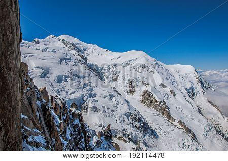 View of the Mont Blanc from the Aiguille du Midi, in French Alps Chamonix Mont Blanc, alpine mountains landscape, clear blue sky in warm sunny summer day