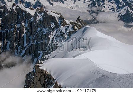 View of snowy peaks from the Aiguille du Midi, in French Alps Chamonix Mont Blanc, alpine mountains landscape, clear blue sky in warm sunny summer day