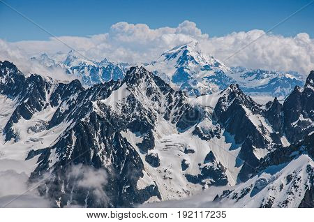 Close up of snowy peaks, view from the Aiguille du Midi, in French Alps Chamonix Mont Blanc, alpine mountains landscape, clear blue sky in warm sunny summer day
