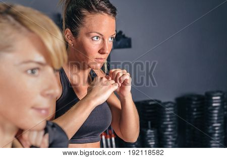 Portrait of beautiful woman training hard boxing in the gym