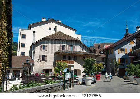 Talloires, France - June 29, 2016. View of street and houses in the village of Talloires, near the Lake of Annecy. Department of Haute-Savoie, Auvergne-Rhône-Alpes region, south-eastern France