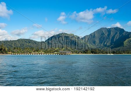 Afternoon from boat trip at Hanalei Bay and pier with the Na Pali coast in the background near Hanalei, Kauai, Hawaii