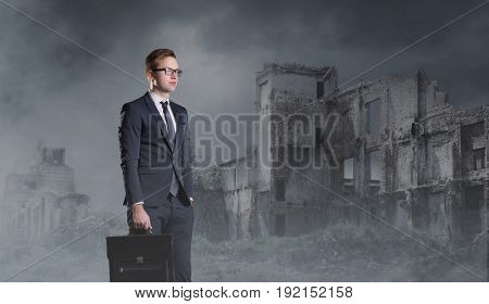 Businessman standing on apocalyptic background. Crisis, default, setback concept.