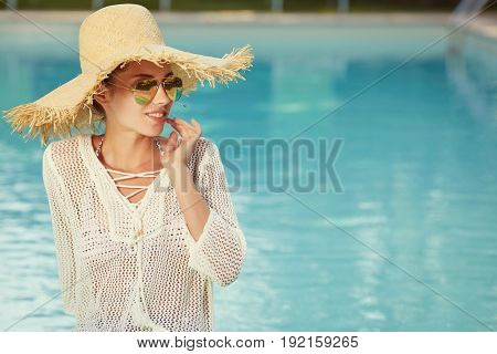 Portrait of beautiful tanned sporty slim woman relaxing in swimm