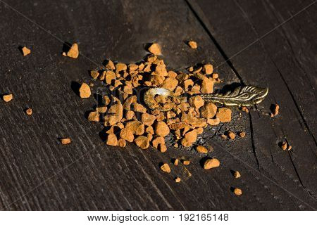 Flavorous morning coffee with a tiny soon at a wooden background close-up
