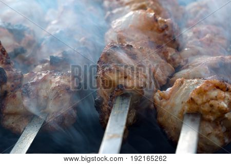 Lamb meat kebab prepares on the fire outdoors
