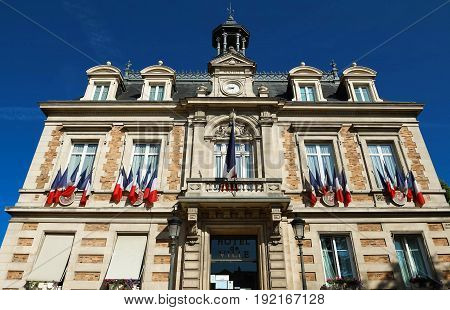 The city hall of Maisons Laffitte town decorated with national French flags, parisian region, France.