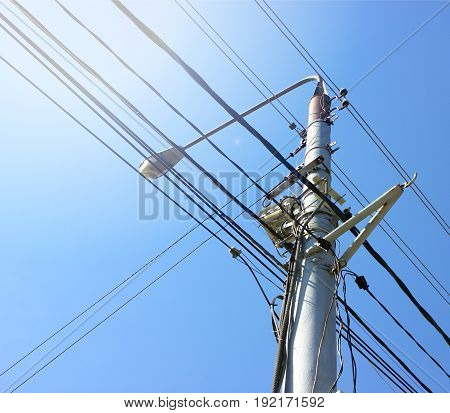 Transmission power tower electricity pylon over blue sky. Steel lattice tower used to support an overhead power line