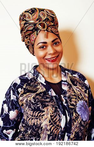 beauty bright african woman with creative make up, shawl on head like cubian closeup smiling, cheerful tan , lifestyle people concept close up