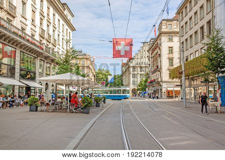 Zurich Shopping Street Bahnhofstrasse With Tram And Swiss Flag