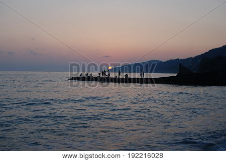Sunset above mountains around sochi fisherfolk black see