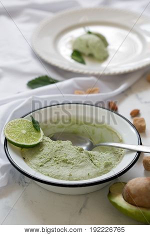 Beautiful composition with hand made tasty ice cream prepared with avocado and lime