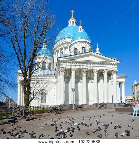 SAINT PETERSBURG RUSSIA - MAY 2 2017: Unknown woman is near Cathedral of Holy Life-Giving Trinity of Life Guards of Izmailovsky Regiment (Troitse-Izmailovsky Cathedral Trinity Cathedral) St. Petersburg