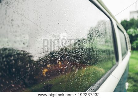 van window outside in rain drops on it