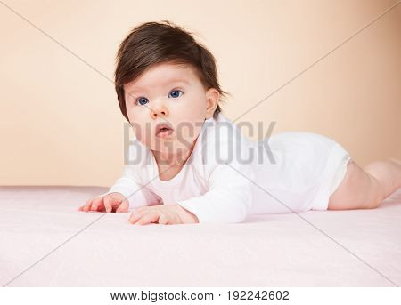 Bright blue eyed beauity 6 month old baby girl.