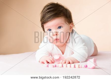 Bright blue eyed beauity 6 month old baby girl.