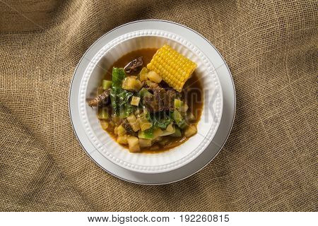 South American Cuisine: Puchero Soup With Chickpeas Close-up In A Pot On The Table.