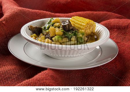 South American Cuisine: Puchero Soup With Chickpeas Close-up In A Pot On The Table.