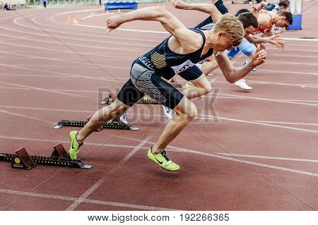 Chelyabinsk Russia - June 4 2017: start sprinters runners men running 100 meters during UrFO Championship in athletics