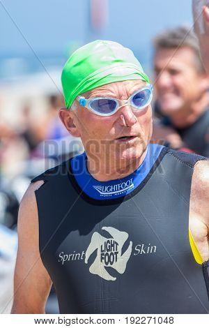 Kijkduin The Hague the Netherlands - 17 June 2017: Kijkduin cross triathlon senior participant about to do swim leg