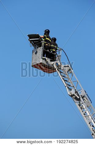 Two Intrepid Firefighters Over The Ladder Truck Metal Basket Dur