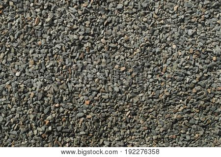 Background of small gray macadam fragments texture
