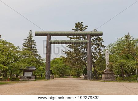 HIROSAKI JAPAN - MAY 23 2017: Large metal torii gate of Gokoku Shinto Shrine in Hirosaki Japan. Shrine is located on the grounds of former Yonnomaru bailey of Hirosaki Castle