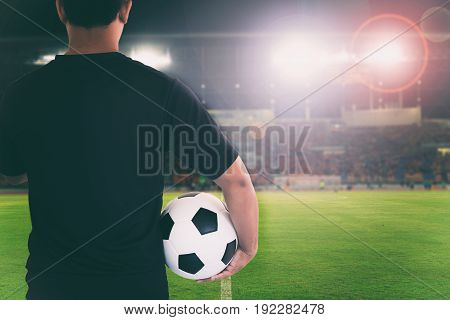 football player holding ball on football stadium for championship win for background