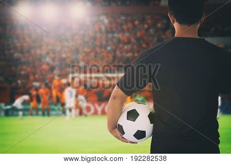 football player holding ball on football stadium for championship win for background