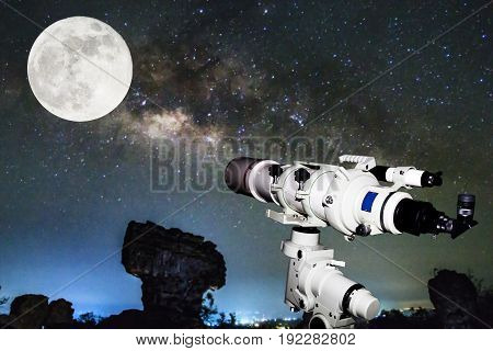 Telescope watching the Milky Way galaxy and Full moon on dark night at thailand