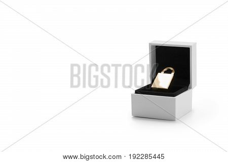 Golden security lock in a jewelry box against white background