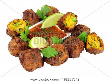 Group of fried vegetable pakora with chilli sauce dip isolated on a white background