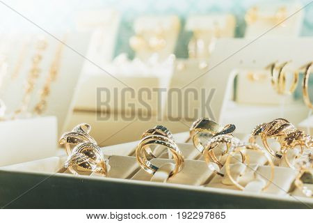 Jewelry in the shop window,Gold rings with diamonds, copy space, toned,