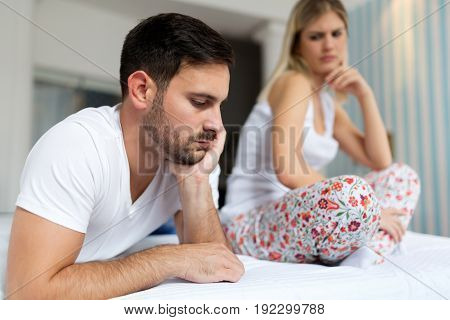 Unhappy sad young couple having unsolved relationship problems
