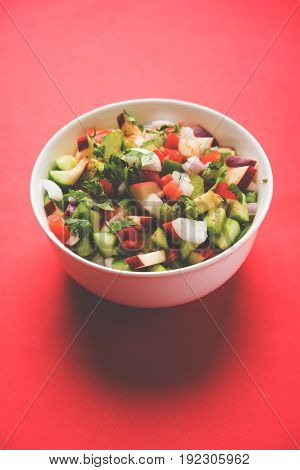 Indian Green Salad also known as Kachumber is a colourful salad dish in Indian cuisine consisting of fresh chopped tomatoes, cucumbers, onions, and sometimes, chili peppers. selective focus