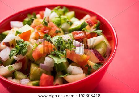 Indian Green Salad also known as Kachumber is a colourful salad dish in Indian cuisine consisting of fresh chopped tomatoes, cucumbers, onions, and sometimes, chili peppers. selective focus