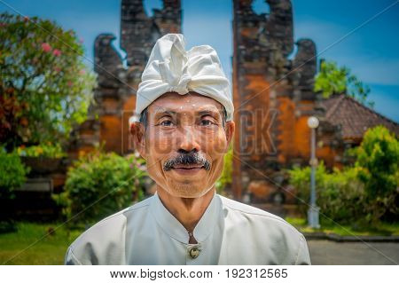 BALI, INDONESIA - MARCH 05, 2017: Unidentified man posing in Pura Ulun Danu Bratan temple on Bali island, Indonesia.