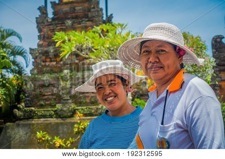 BALI, INDONESIA - MARCH 05, 2017: Unidentified women posing in Pura Ulun Danu Bratan temple on Bali island, Indonesia.