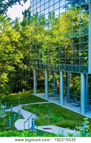 TWINSBURG OH - JUNE 12 2016: A modernistic glass wall of the Twinsburg branch of the Cleveland Clinic beautifully mirrors the natural setting that surrounds it.