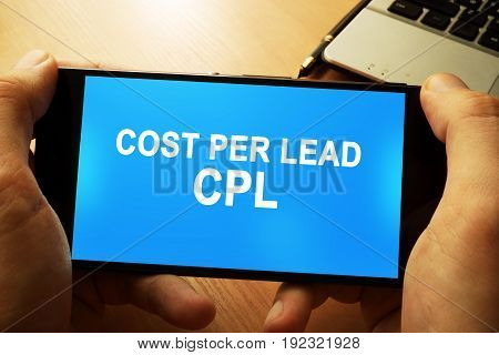 Hand holding smartphone with words Cost per lead CPL.