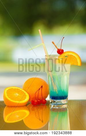 Non-alcoholic drink and fruit on a table with a blurred background.
