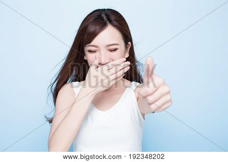 beauty woman show thumbup on the blue background