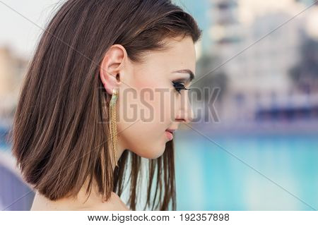 Portrait of young female with short brown hair and evening make up with fake eyelashes. Bob cut hairstyle