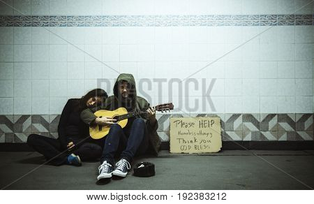 Homeless Couple Man Playing Guitar Asking For Money Donation